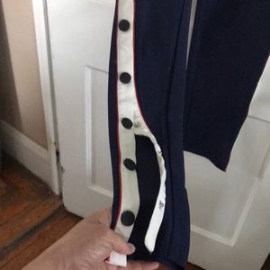 Navy Blue track pants.  With red trim and buttons